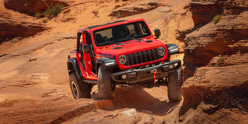 Red Jeep Wrangler in desert