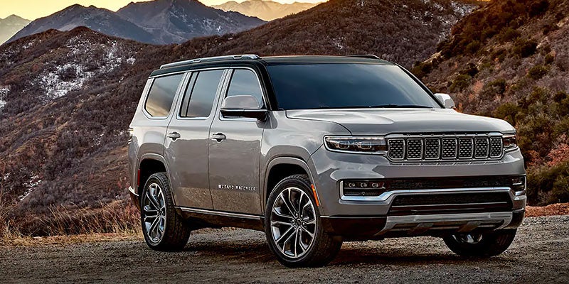 Jeep Grand Wagoneer SUV driving through river road view