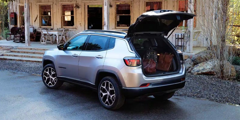 Jeep Compass SUV with open trunk parked outside