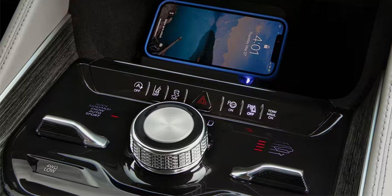 A smartphone charging inside a Jeep Wagoneer