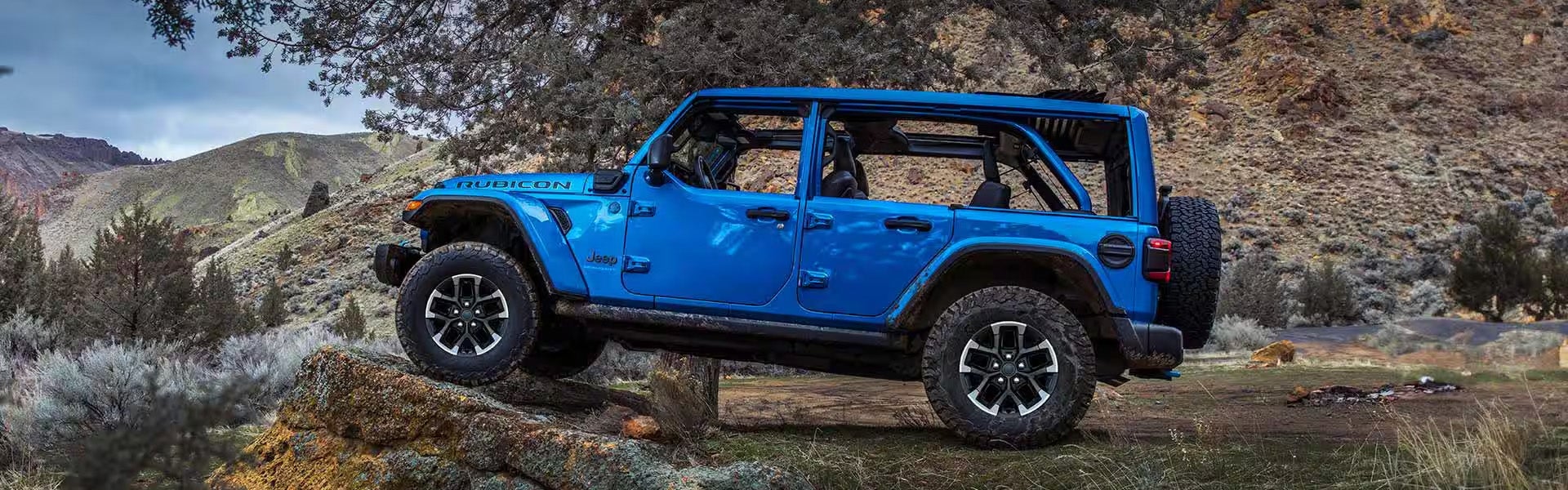 Jeep Wrangler off-roading on rocky mountain terrain