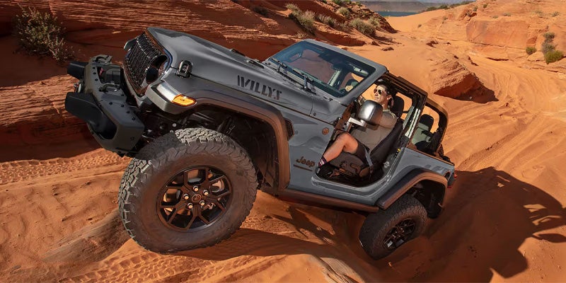 Jeep Wrangler Willys climbing steep red rock terrain